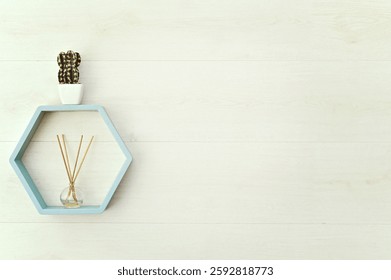 hexagonal wooden shelf on the wall with flowers and aroma diffuser. mock up