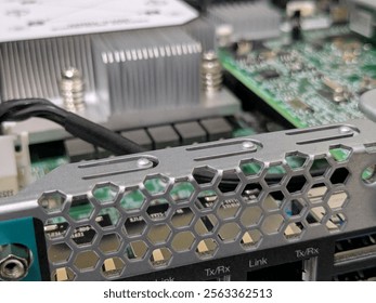 Hexagonal-patterned ventilation of a PC server showing various internal electronic components, including a heatsink, Link and Tx Rx ports.