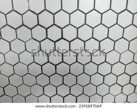 Hexagon-shaped plastic material attached to the wall forms an abstract background