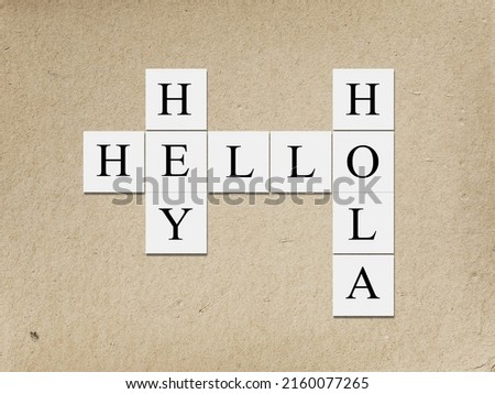 Hey Hola Hello letters, tiles against abstract background.