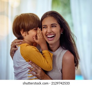 Hey mom guess what I love you. Shot of an adorable little boy whispering into his mothers ear.