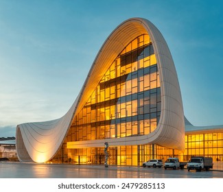 The Heydar Aliyev Centre in Baku, Azerbaijan, glows warmly in the evening with its unique, flowing architecture - Powered by Shutterstock