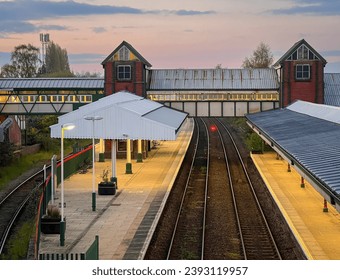 Hi angle view of the platforms and tracks of the  railway station at dusk, in the city of Wrexham, North Wales, UK - Powered by Shutterstock