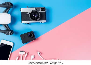Hi tech travel gadget and accessories on blue and pink copy space, including drone camera mobile phone top view flay lay for Vacation Video footage filming tools.  - Shutterstock ID 671867245