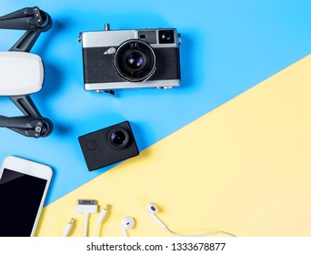 Hi tech travel gadget and technology toy accessories on blue and yellow copy space. For Modern videography and vlogging poster and banner use with copy space. - Shutterstock ID 1333678877