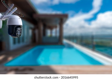 Hi Technology 4G Mini Dome Camera , IP Wifi Wireless Connection CCTV Support Motion Detection And Microphone Is Home Security System Concept With Swimming Pool Background.