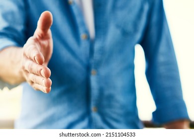 Hi There. Closeup Shot Of An Unrecognizable Businessman Extending A Handshake.