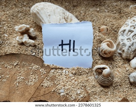 Hi writing on beach sand background.