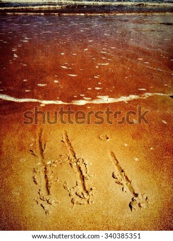 Hi written in sand