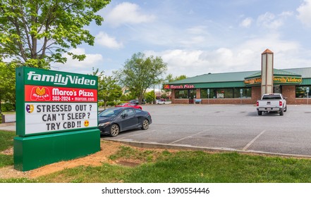 HICKORY, NC, USA-5/3/19: A Family Video Store, With Street Sign Advertising CBD (cannabidiol) For Sale.