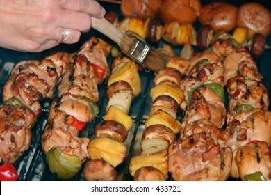 Hickory Smoked Marinated Chicken Shish Kabobs With Green And Red Bell Peppers.  Accompanying The Feast Is Red Potatoes And Vegetable Kabobs Consisting Of Pineapple,onion,and Mushrooms.