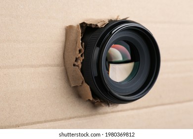 Hidden Camera Lens Through Hole In Cardboard, Closeup