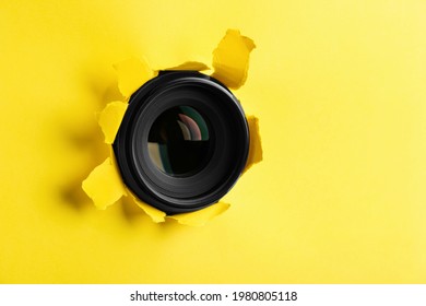 Hidden Camera Lens Through Hole In Yellow Paper