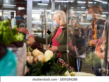 Hidden Camera View At The Senior Short Haired Blonde Woman Picking Up The Purchase From The Seller While Buy The Cabbage At The Market