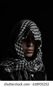 Hidden Man With Palestinian Scarf Over Head In Front Of Isolated Black Background