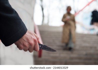 Hidden Maniac, Bully And Abuser With Knife In Ambush Follows And Waits For A Female Victim To Surprise And Attack Woman In An Underground Passage On The Stairs. Horror Psycho Scene