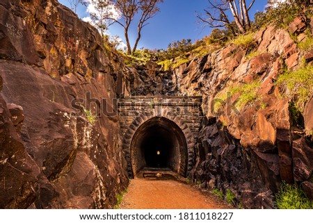 Hidden old train tunnel at national park with rock formation valley