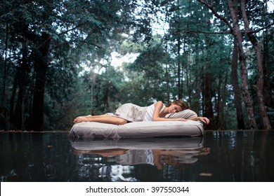 A hidden place. Sleeping woman in deep forest lies on airbed