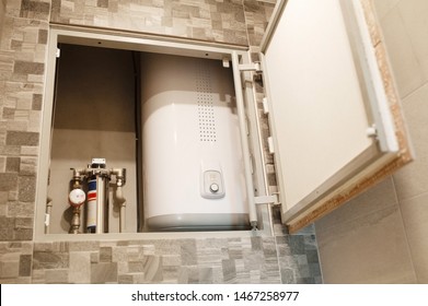 hidden revision hatch with boiler on the wall in a bathroom - Shutterstock ID 1467258977