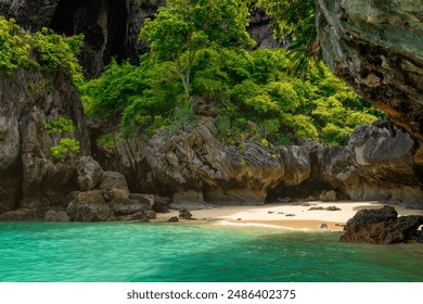 Hidden sandy beach in Phra Nang cave with nobody, Railay Bay, Krabi, Thailand. Secret tropical beach with turquoise water, green plants and rocks. Popular touristic vacation holiday destination - Powered by Shutterstock