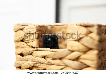Hidden spy camera in wicker box indoors, closeup