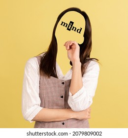 Hidden thoughts. Contemporary artwork. Portrait of faceless girl with word mind instead face isolated on yellow background. Human psychology, character traits, emotions, mental health concept. - Shutterstock ID 2079809002
