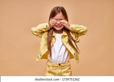 Hide And Seek. Sweet Caucasian Girl Closed Her Eyes With Hands Isolated. Play Hide And Seek. Games, Children Concept