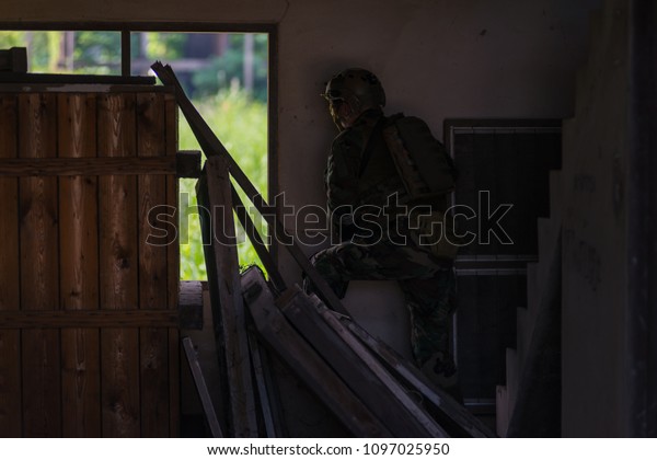 Hiding for safety in\
military combat.
