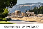 Hierapolis ruins framed by nature with mountains backdrop. Pamukkale, Denizli, Turkey (Turkiye)