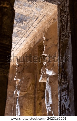 Hieroglyphs and pharao statues inside The Great Temple of Ramesses II