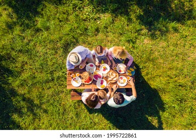 High Above Angle View Family Having Meal In Garden Sunny Summer Day