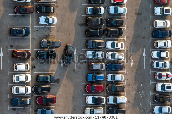 High\
above birds eye view of a public car parking lot.\
