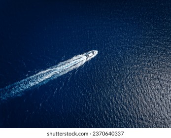 High aerial view of a luxury yacht traveling over the sparkling ocean - Powered by Shutterstock