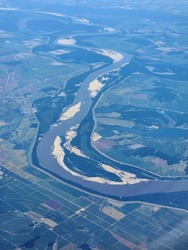 High Altitude Aerial View Of Mississippi River And Surrounding Agricultural Fields Near Memphis Tennessee On Clear Sunny Day.