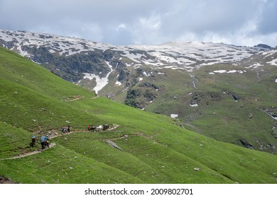 High altitude Bhrigu lake trek on meadows and snow capped mountains - Shutterstock ID 2009802701