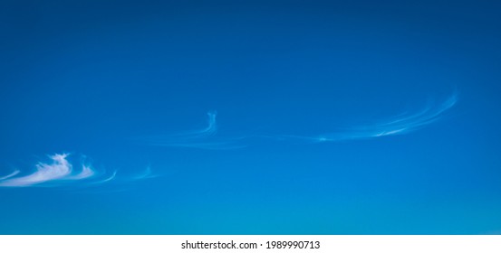 High Altitude Cirrus Clouds In The Form Of Curly Hooks. Latin Name Of These Clouds Is Cirrus Uncinus.