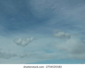 High altitude cloud formations drifting across soft blue sky creating natural atmospheric texture