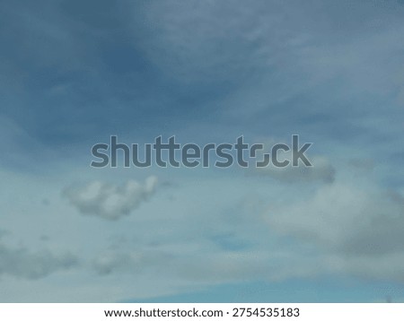High altitude cloud formations drifting across soft blue sky creating natural atmospheric texture