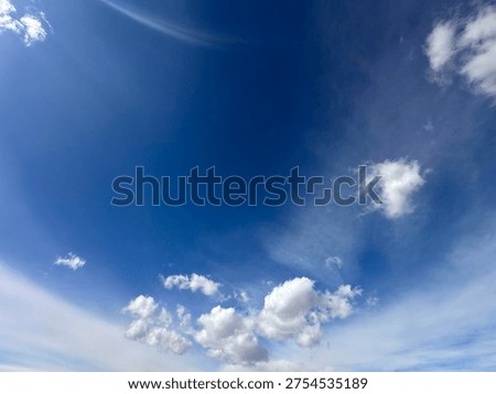High altitude cloud formations drifting across soft blue sky creating natural atmospheric texture
