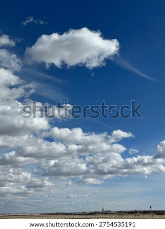 High altitude cloud formations drifting across soft blue sky creating natural atmospheric texture