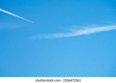 high altitude contrails from a KLM Boeing 787-10 dreamliner heading East en route to Amsterdam airport Schipol Netherlands