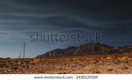 High altitude smoke tendrils from distant California wildfires, flow with the prevailing wind currents outside Death Valley National Park. 