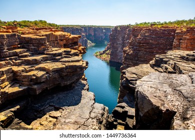 high angel view over King George River Gorge and plateau in the Kimberleys  with lush bushes and sandstone formation in  the foreground and background