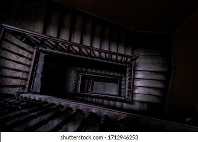 High angle above view down of old vintage staircase winding spiral in Lviv, Ukraine, Europe with nobody architecture dark low-key abstract pattern