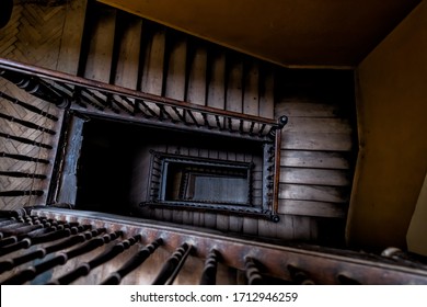 High angle aerial above view down of old vintage staircase winding spiral in Lviv, Ukraine, Europe with nobody architecture dark low-key abstract pattern