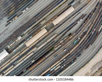 High Angle Aerial Top Down Bird's Eye View Of Many Railroad Train Track And Many Cargo Container Train At Big Train Station.