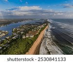 High Angle aerial view of Boynton Beach Florida after a cloudy sunrise. Looking North with the Atlantic Ocean on the right and The Inlet on the left.