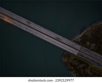 A high angle, aerial view of the Loop Parkway which crosses over the marshlands in Baldwin Bay. Taken during a cloudy sunset in autumn, near Freeport, New York.