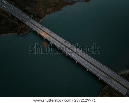 A high angle, aerial view of the Loop Parkway which crosses over the marshlands in Baldwin Bay. Taken during a cloudy sunset in autumn, near Freeport, New York.