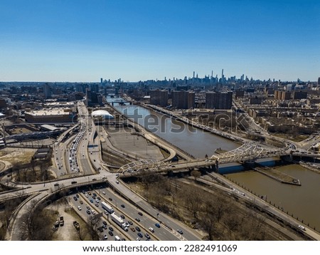 A high angle, aerial view of the McCombs Dam Bridge crossing the Harlem River in New York. Taken on a sunny day with a drone camera.